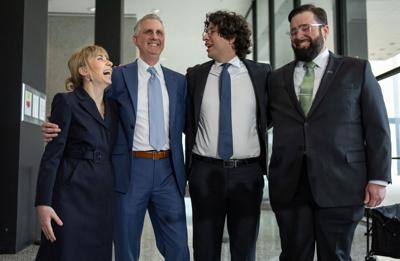 “Broadview Six” defendants Kat Abughazaleh, from left, Michael Rabbitt, Andre Martin and Brian Straw embrace outside the Dirksen U.S. Courthouse after federal prosecutors dismissed all remaining counts, May 21, 2026.
